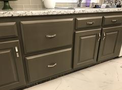 refinished lower kitchen cabinets in dark sage with white marble counter tops