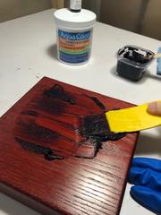 Aqua Coat grain filler used with a dark red stain on a piece of wood