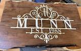 DIY wooden sign with the name Munn est. 1988 written on it in white