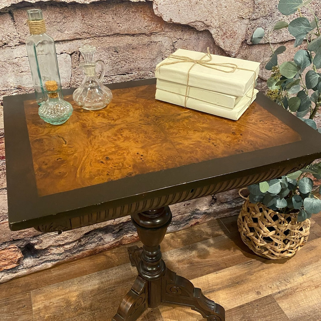 Wood side table with a stack of three white books and three glass jars sitting on top