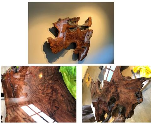 wood slab wall art stained a dark brown with a very glossy finish