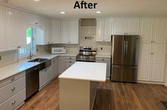 kitchen with newly painted white cabinets and an island