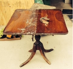 wooden side table in the process of being refinished